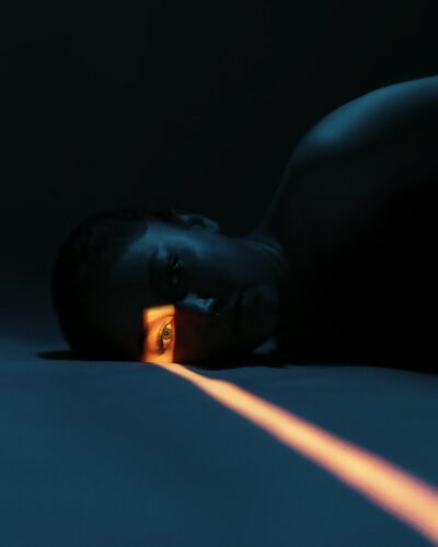 Artistic portrait using dramatic low light effects, emphasizing mystery.