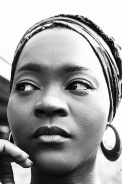 Striking black and white portrait of an African woman with confident expression.